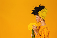 Portrait Of Happy Black Woman Smiling At A Bouquet Of Daffodils Photo